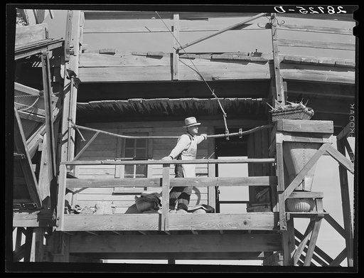 At the sugar beet unloading station a sample of each farmer's load is taken to determine the tare or quantity of soil adhering to the beets. This is deducted from the weight on which payment is based. Adams County, Colorado
