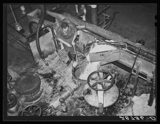 Loading diffusion chamber with sugar beet pulp in factory at Brighton, Colorado