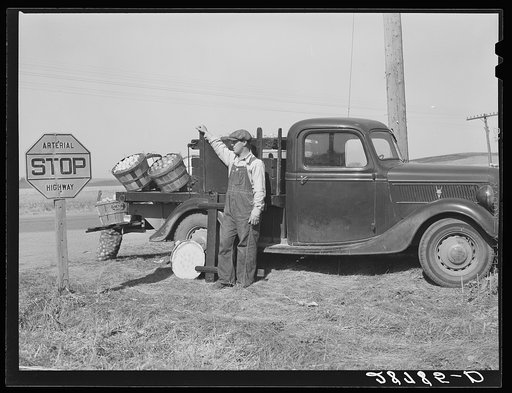 Farmer selling produce on highway. Marshall County, Iowa