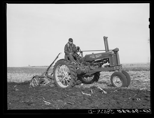 Fred Wilfang, rehabilitation client, uses modern tractor bought with FSA (Farm Security Administration) loan. Black Hawk County, Iowa