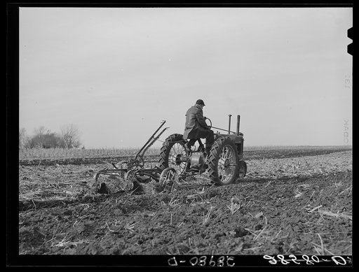 Untitled photo, possibly related to: Fred Wilfang, rehabilitation client, uses modern tractor bought with FSA (Farm Security Administration) loan. Black Hawk County, Iowa
