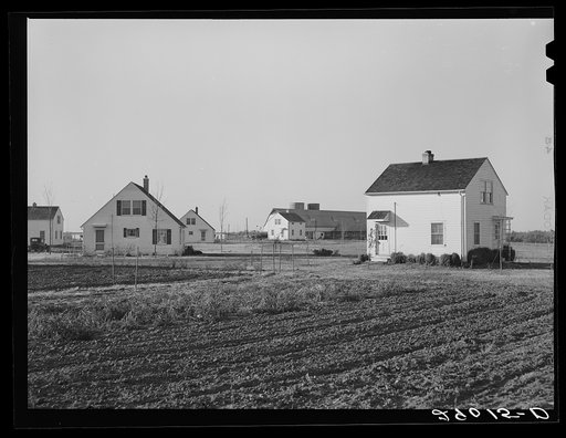 Group of homes located near the dairy farms on Bois d'Arc Cooperative farm. The same well and pump that furnishes water for the barns serves to supply the homes. Osage Farms, Missouri