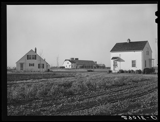 Untitled photo, possibly related to: Group of homes located near the dairy farms on Bois d'Arc Cooperative farm. The same well and pump that furnishes water for the barns serves to supply the homes. Osage Farms, Missouri