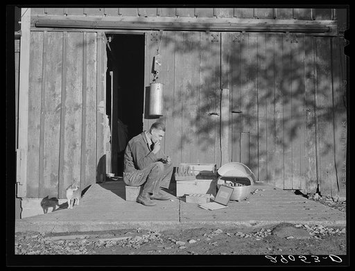 A milk tester for the Triple B milk testing associations. His equipment includes test tubes, pipettes, a centrifuge and laboratory apparatus seldom found on the farm. Black Hawk County, Iowa