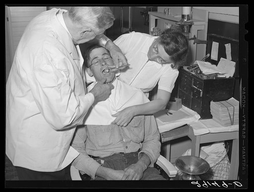 Dentist participating in FSA (Farm Security Administration) health program treats rehabilitation client. Saint Charles County, Missouri