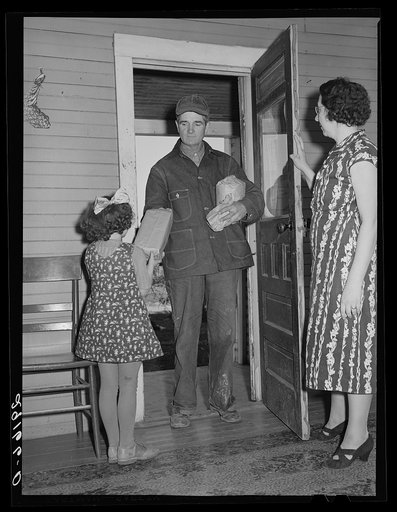Farmer arrives home after shopping in town. Greene County, Missouri