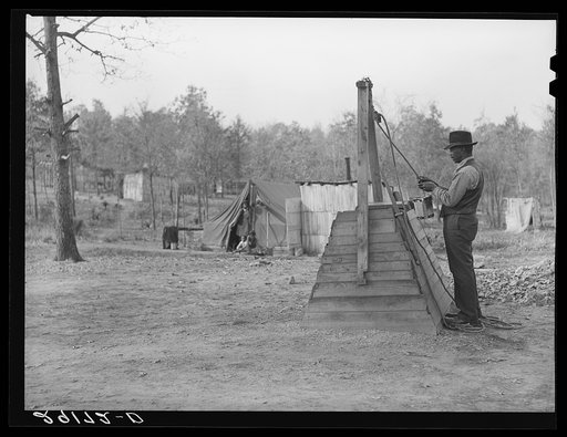 Evicted sharecropper at well. Butler County, Missouri