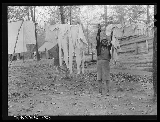 Taking down the washing at evicted sharecroppers' camp. Butler County, Missouri