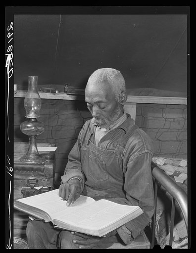 Evicted sharecropper reading the Bible. Butler County, Missouri