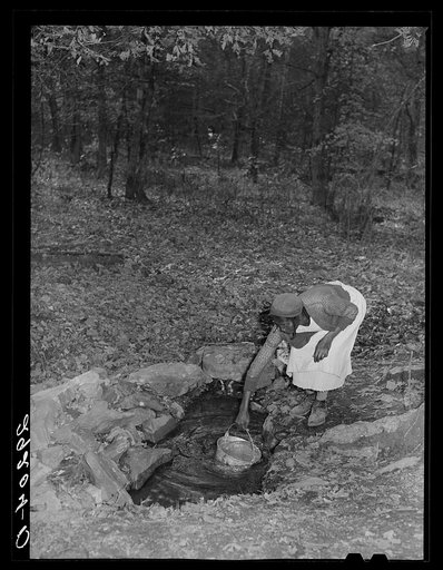 Woman at spring. Evicted sharecropper camp. Butler County, Missouri