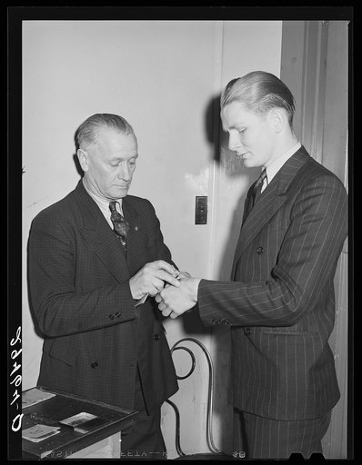 Dancers are marked with rubber stamp as they enter the hall. Marshalltown, Iowa