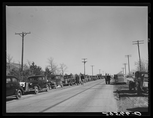 Farmer's cars line the highway near Zimmerman farm auction. Hastings, Nebraska