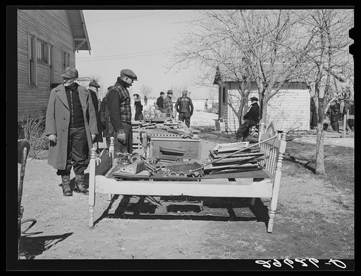 Neighbors examine furniture to be auctioned at P.C. Zimmerman's farm near Hastings, Nebraska