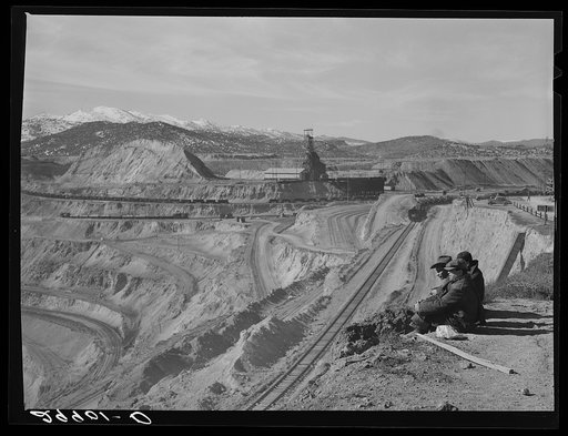 Workers sitting at edge of copper pit. Ruth, Nevada