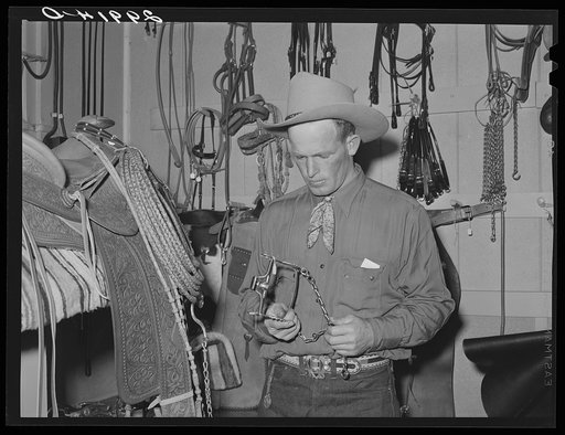 Cowhand examining bit. Capriola Saddlery, Elko, Nevada