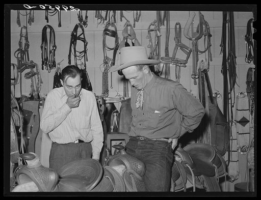 Untitled photo, possibly related to: Cowhand tries on chaps. Capriola Saddlery, Elko, Nevada
