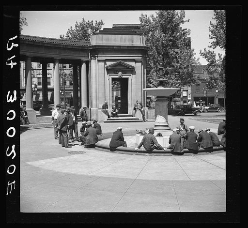 Men sitting in park square fountain. Minneapolis "Gateway" district