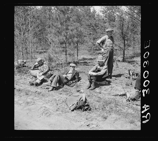 Lumberjacks resting by roadside near Littlefork, Minnesota