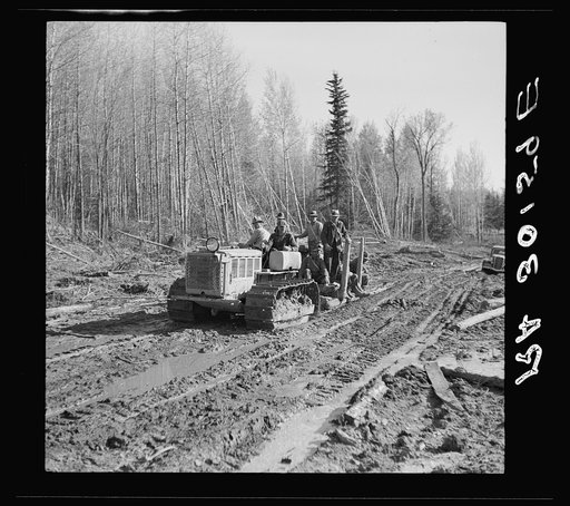 Tractor carrying men from work. Near Littlefork, Minnesota
