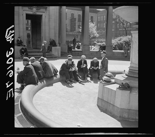 Unemployed men sitting in public square in the Minneapolis "Gateway" district. Minnesota
