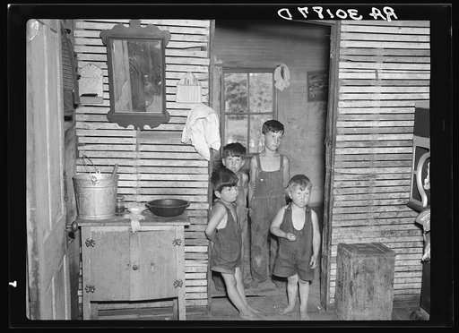 Art Simplot's sons in the kitchen and washroom of their home near Black River Falls, Wisconsin. Note the unplastered walls