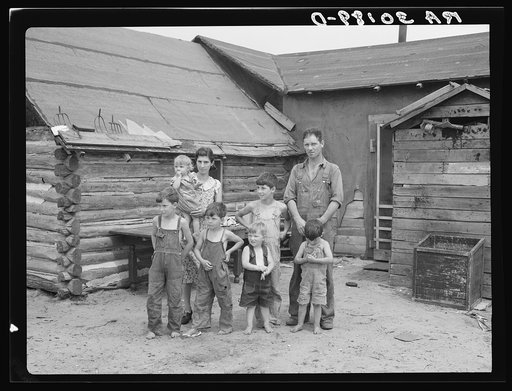 Art Simplot and family in front of their house near Black River Falls, Wisconsin