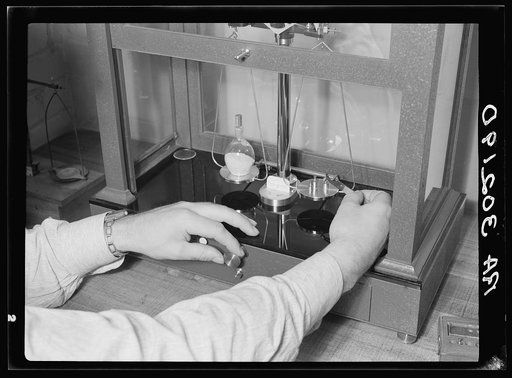 Weighing material on balance. Forest Products laboratory, Madison, Wisconsin
