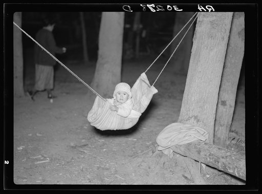 Indian baby in blueberry picker's camp. Littlefork, Minnesota