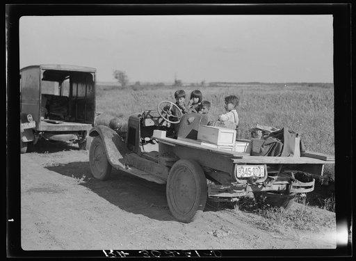 Children of Indian blueberry pickers in truck. Note boxes for blueberries and clothes. Near Littlefork, Minnesota