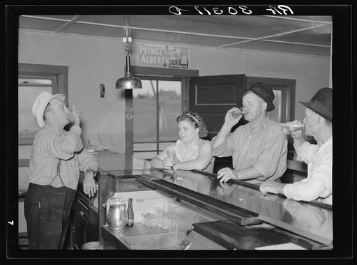 A drink on the house. Lumberjacks, proprietor and lady attendant in saloon. Craigville, Minnesota