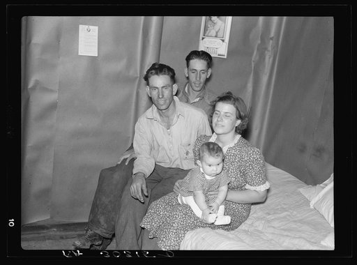 Family and brother-in-law living in tarpaper shack in abandoned lumbercamp. Gemmel, Minnesota
