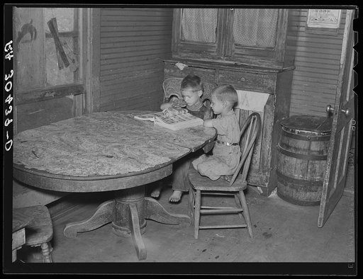 Children of Frank Weeks looking through a catalogue