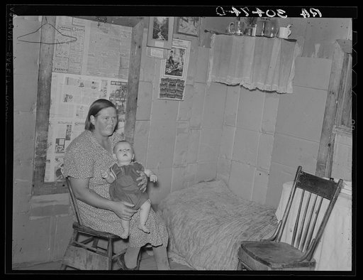 Mrs. H. Gerling and baby in living room in farmhouse near Wheelock, North Dakota
