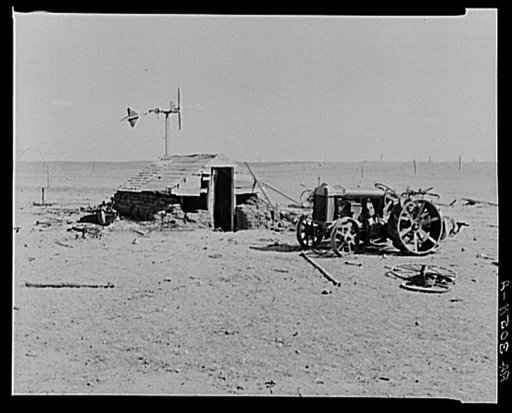 Idle tractor and machine shed on farm in drought-stricken Williams County, North Dakota