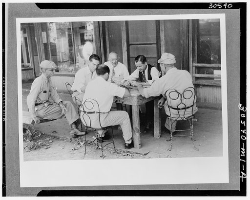 Playing dominoes or cards in front of drug store in center of town in Mississippi Delta, Mississippi