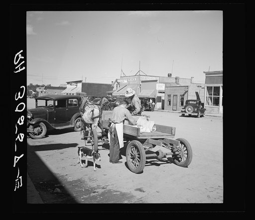 Loading supplies into farmer's wagon. Littlefork, Minnesota