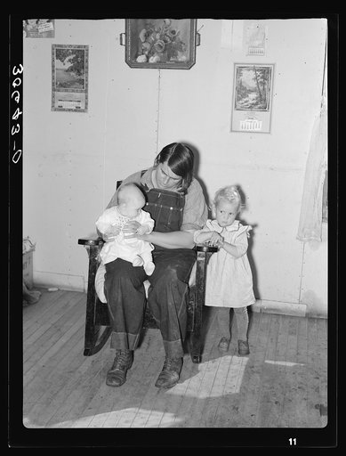 Mrs. Charles Swanson and her two children on farm near Northome, Minnesota