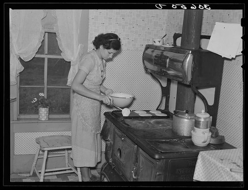 Mrs. Orville White making pancakes for breakfast near Northome, Minnesota