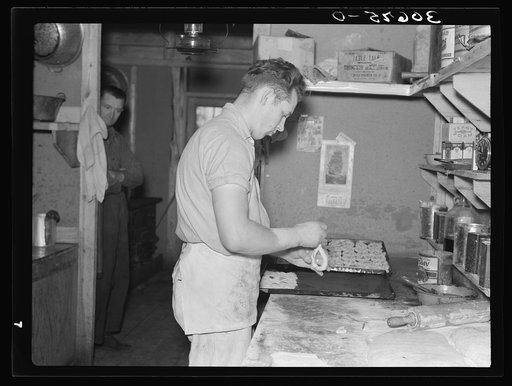 Camp cook making rolls. Logging camp near Effie, Minnesota