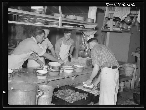 Dishing out and serving food in logging camp near Effie, Minnesota