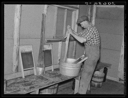 Lumberjack washing clothes. Camp near Effie, Minnesota