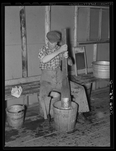 Lumberjack washing clothes at logging camp near Effie, Minnesota
