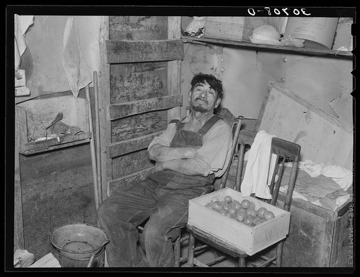 Father of beet worker family resting after a day's work. East Grand Forks, Minnesota