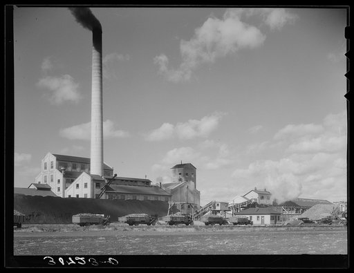 Untitled photo, possibly related to: Sugar beet factory with trucks lined up waiting to be unloaded. East Grand Forks, Minnesota