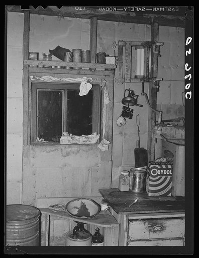 Kitchen window stuffed with towels and clothing in dust storm area. Williams County, North Dakota