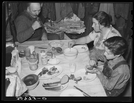 Noonday meal of Ole Thompson family, Williams County. No vegetables, but chicken because it is cheapest meat as it is raised on the farm