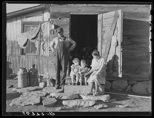 A farmer and his family in front of home. Williams County, North Dakota