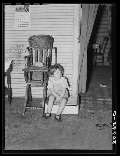 Daughter of farm laborer and old fashioned highchair. Williams County, North Dakota