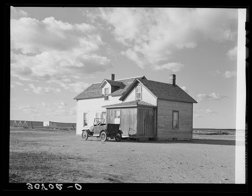 Farmhouse and old car. Williams County, North Dakota