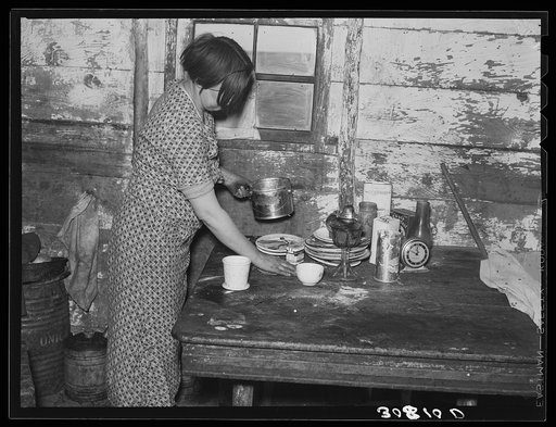 Wife of Joe Kramer working in the kitchen. Farm near Williston, North Dakota